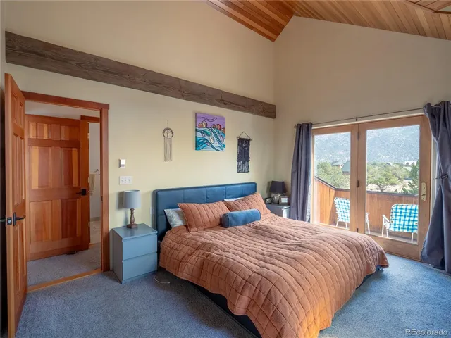 a bedroom with a large bed and a large window