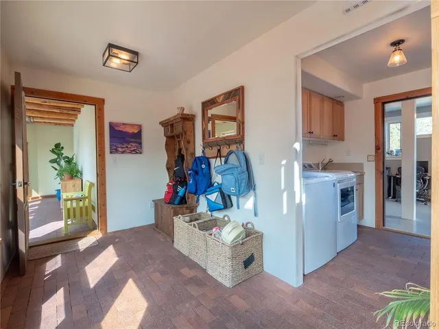a living room with furniture and a gym equipment