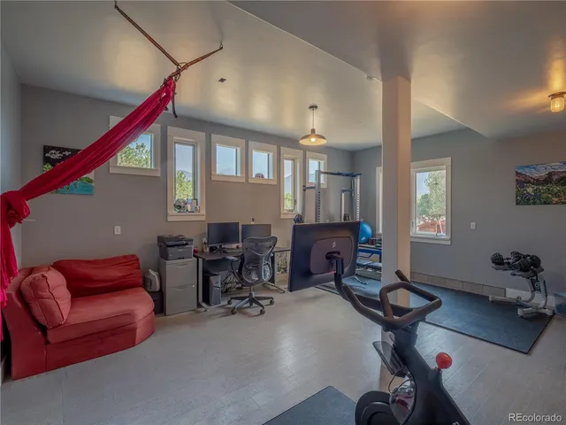 a livingroom with workspace and a couch