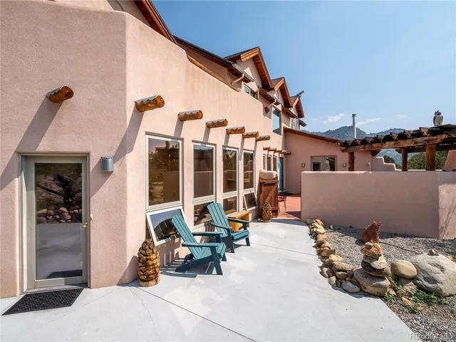 a view of a terrace with chairs and potted plants