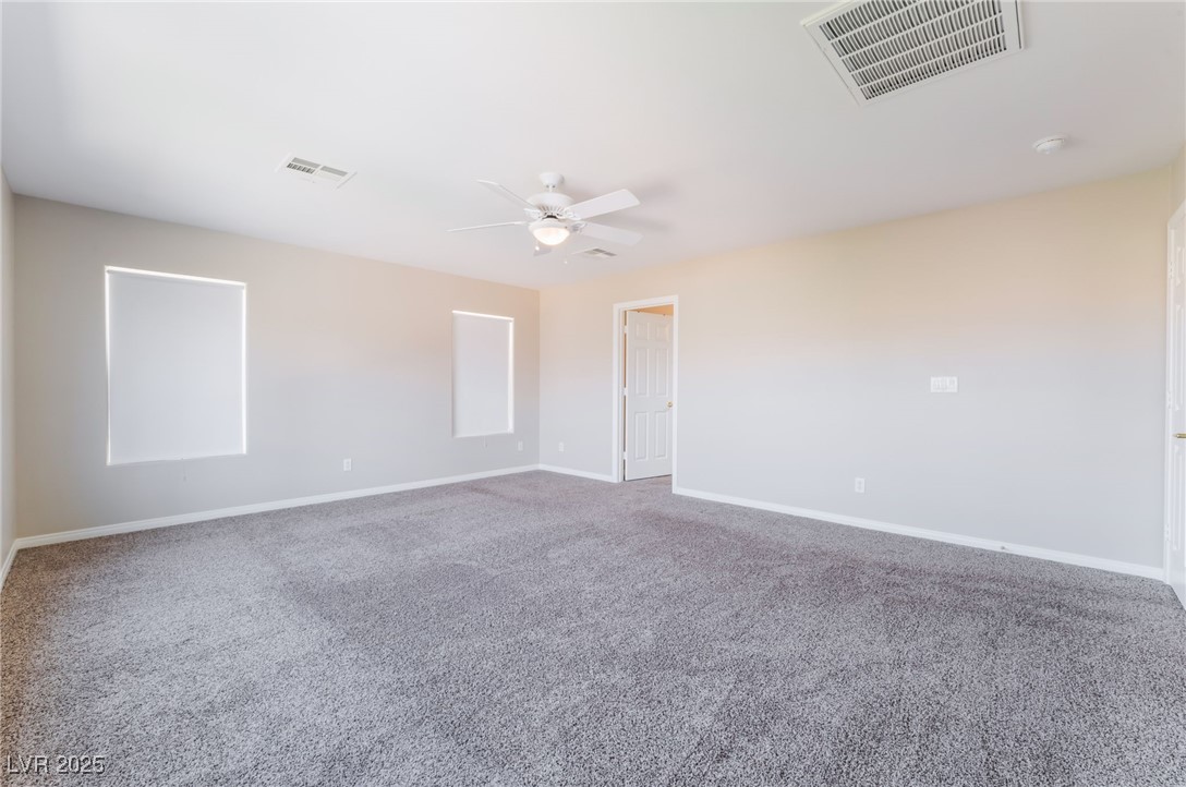 7857 Midnight Ride Street Las Vegas, NV 89131 - Photo 18 of 53 Spare room with ceiling fan, carpet flooring, and baseboards