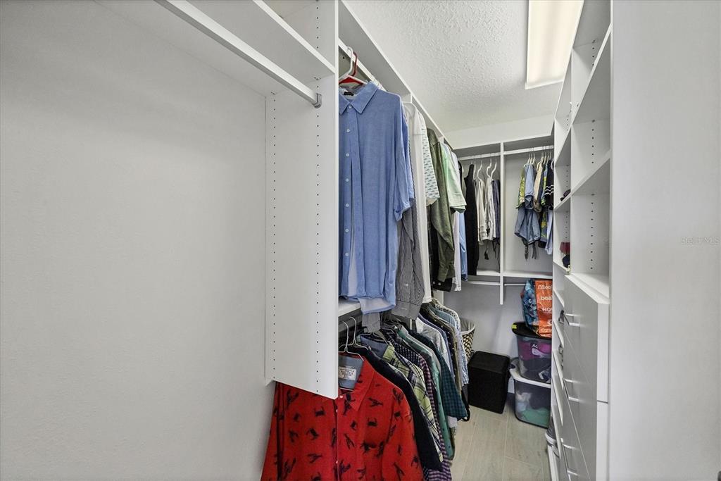 139 Inlets Boulevard, Unit 139 Nokomis, FL 34275 - Photo 17 of 59 a view of walk in closet with clothes and shoes