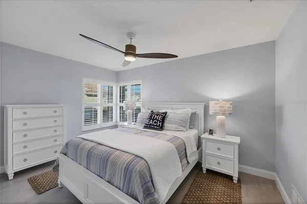a bedroom with a bed a desk and chair