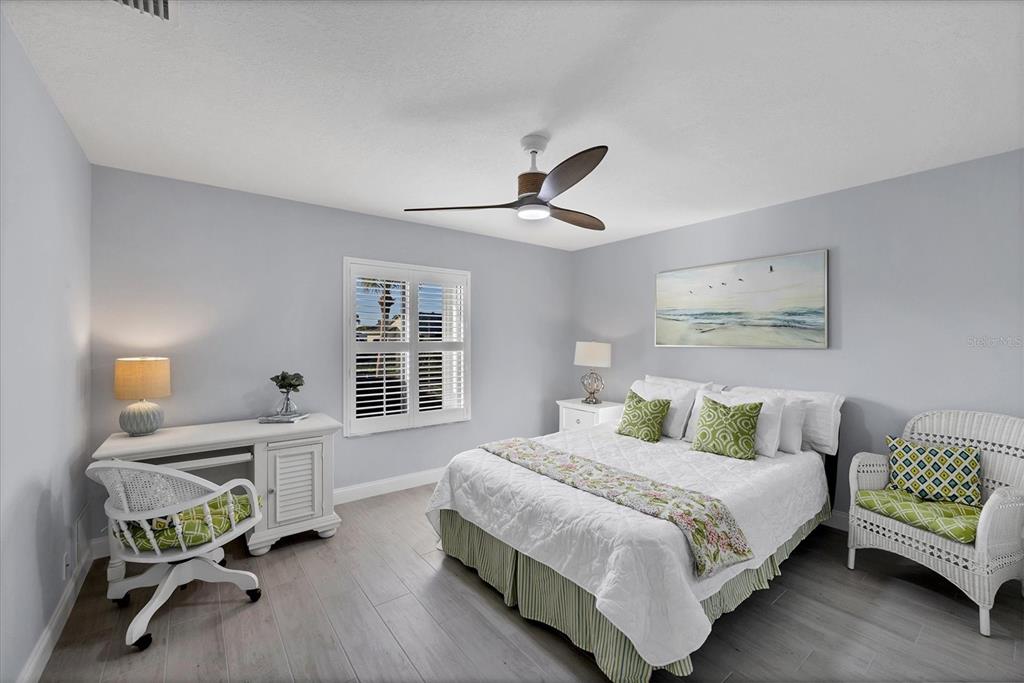 139 Inlets Boulevard, Unit 139 Nokomis, FL 34275 - Photo 20 of 59 a bedroom with a bed a desk and chair