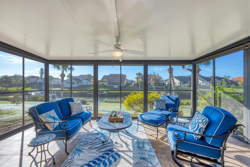 139 Inlets Boulevard, Unit 139 Nokomis, FL 34275 - Photo 21 of 59 a living room with furniture and a floor to ceiling window