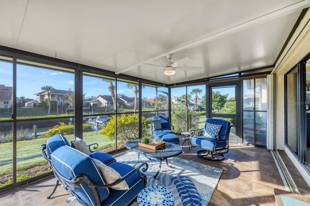 139 Inlets Boulevard, Unit 139 Nokomis, FL 34275 - Photo 22 of 59 a living room with furniture and floor to ceiling windows
