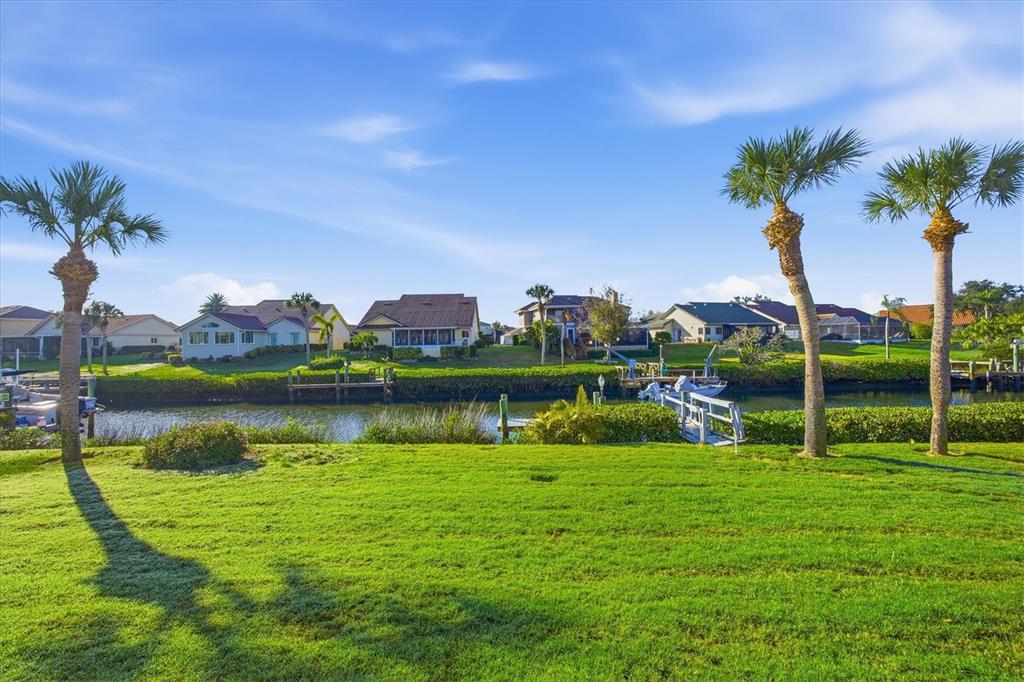 139 Inlets Boulevard, Unit 139 Nokomis, FL 34275 - Photo 24 of 59 a view of a garden with a lake