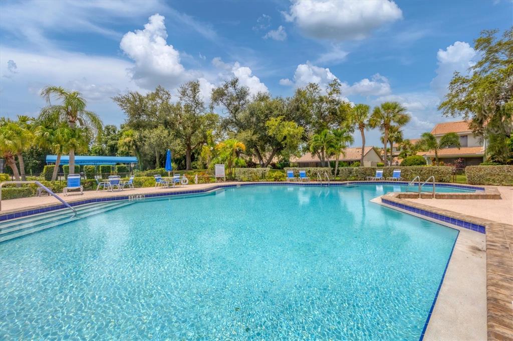 139 Inlets Boulevard, Unit 139 Nokomis, FL 34275 - Photo 36 of 59 a view of a swimming pool with an outdoor space and seating area