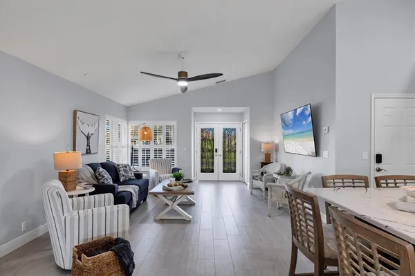 a living room with furniture and a potted plant