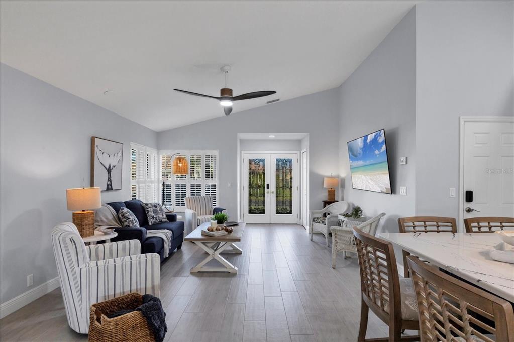 139 Inlets Boulevard, Unit 139 Nokomis, FL 34275 - Photo 5 of 59 a living room with furniture and wooden floor