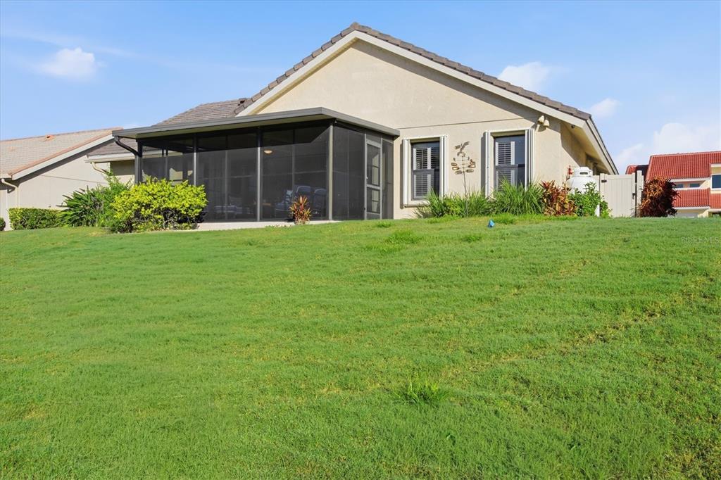139 Inlets Boulevard, Unit 139 Nokomis, FL 34275 - Photo 53 of 59 a front view of a house with a yard and garage