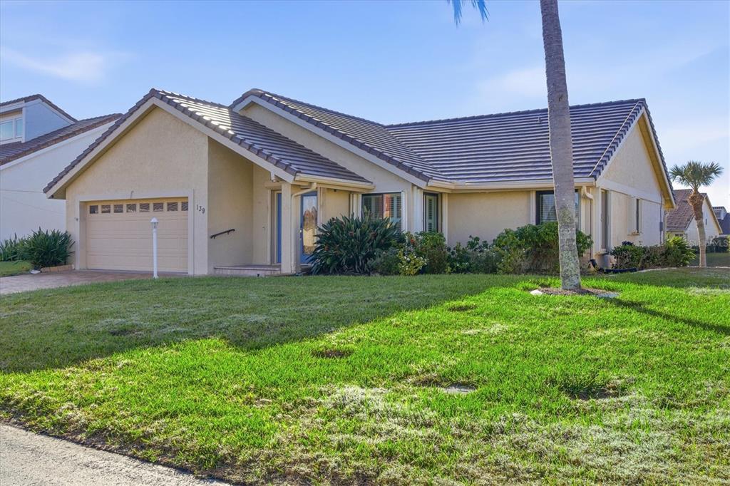 139 Inlets Boulevard, Unit 139 Nokomis, FL 34275 - Photo 55 of 59 a view of a house with yard and plants