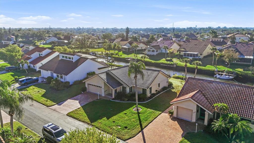 139 Inlets Boulevard, Unit 139 Nokomis, FL 34275 - Photo 57 of 59 an aerial view of a house with a garden