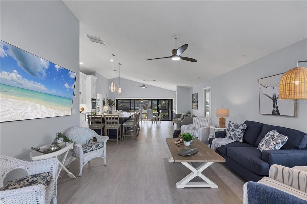 139 Inlets Boulevard, Unit 139 Nokomis, FL 34275 - Photo 6 of 59 a living room with furniture kitchen view and a wooden floor