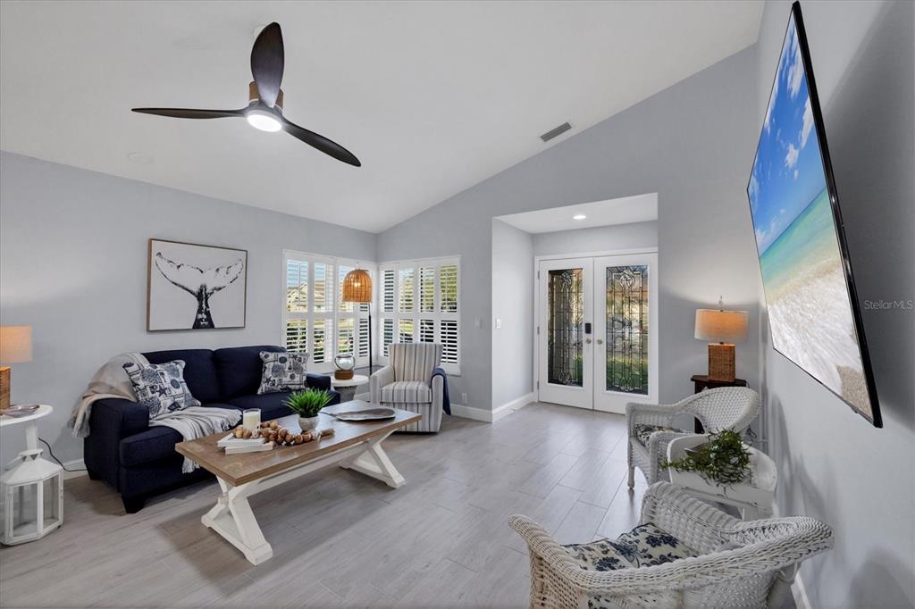 139 Inlets Boulevard, Unit 139 Nokomis, FL 34275 - Photo 7 of 59 a living room with furniture and a potted plant