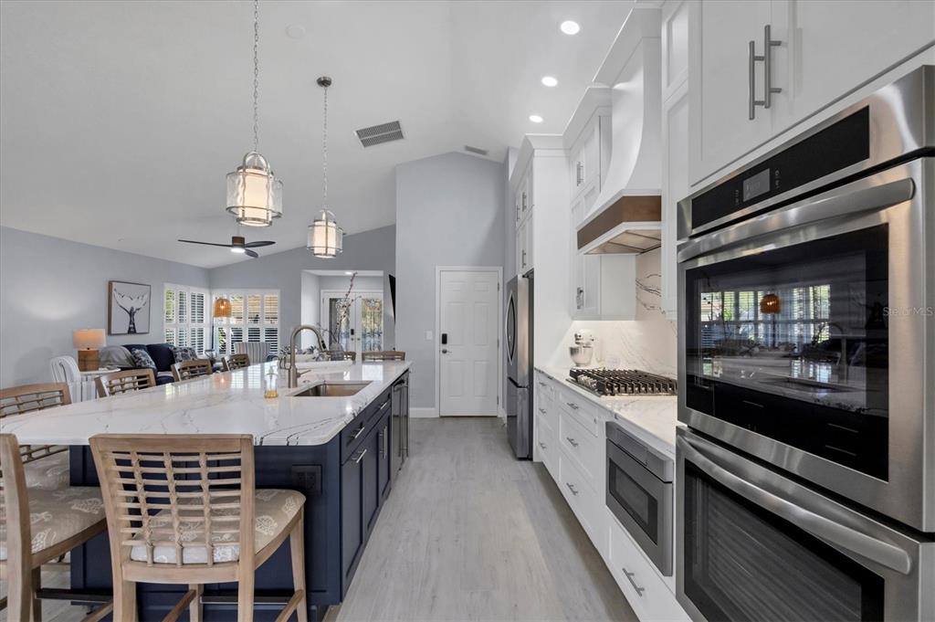 139 Inlets Boulevard, Unit 139 Nokomis, FL 34275 - Photo 10 of 59 a kitchen with kitchen island granite countertop lots of counter top space and stainless steel appliances