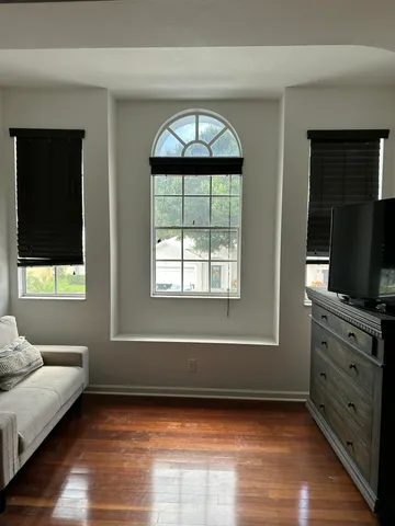 a bedroom with a bed and a mirror