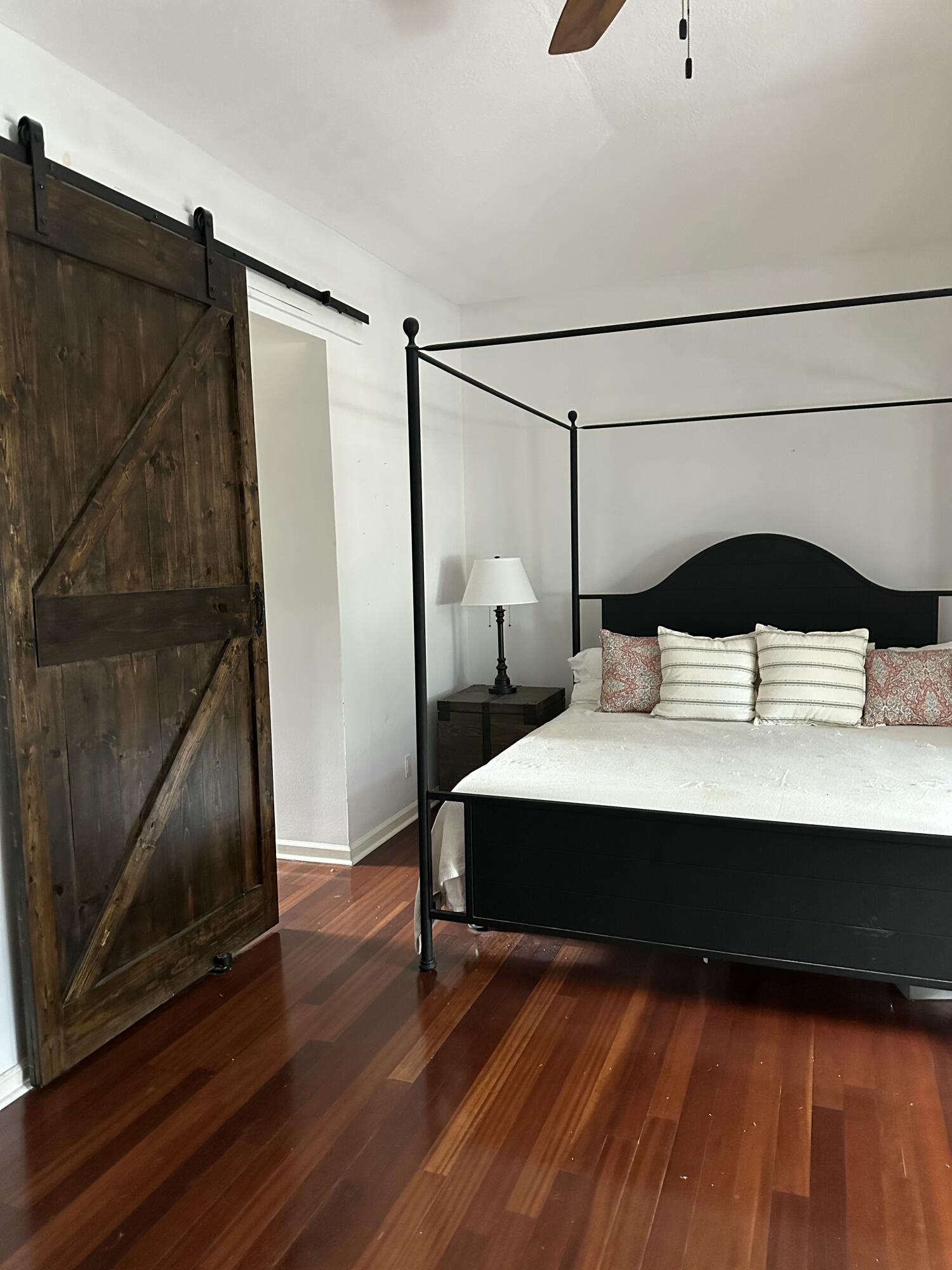 115 Spoonbill Court Jupiter, FL 33458 - Photo 22 of 52 a bedroom with a bed and a mirror