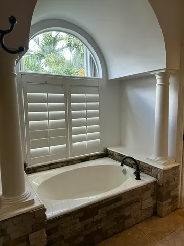 a white toilet sitting next to a shower
