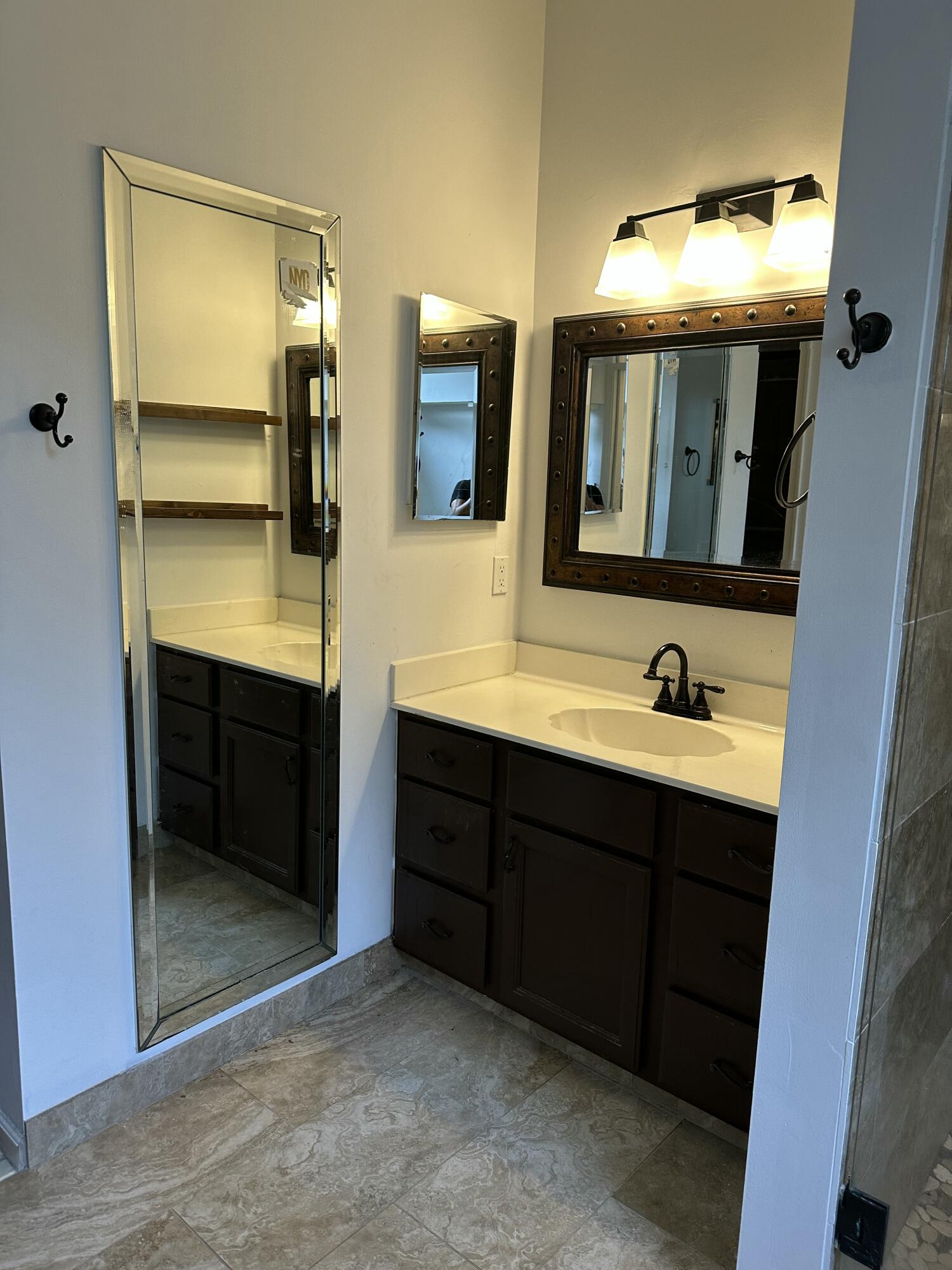 115 Spoonbill Court Jupiter, FL 33458 - Photo 30 of 52 a bathroom with a double vanity sink and mirror