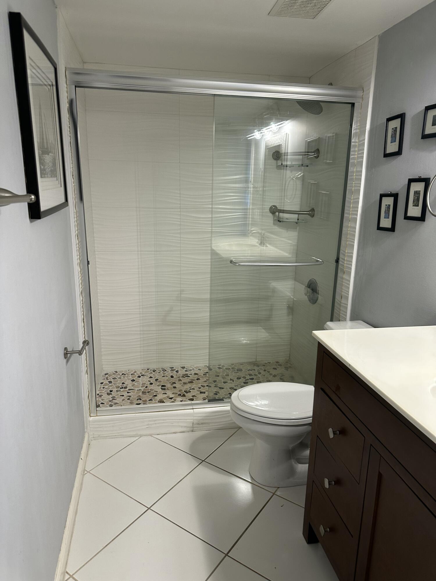 115 Spoonbill Court Jupiter, FL 33458 - Photo 34 of 52 a bathroom with a granite countertop sink toilet and shower
