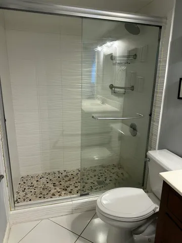 a bathroom with a sink vanity and a toilet