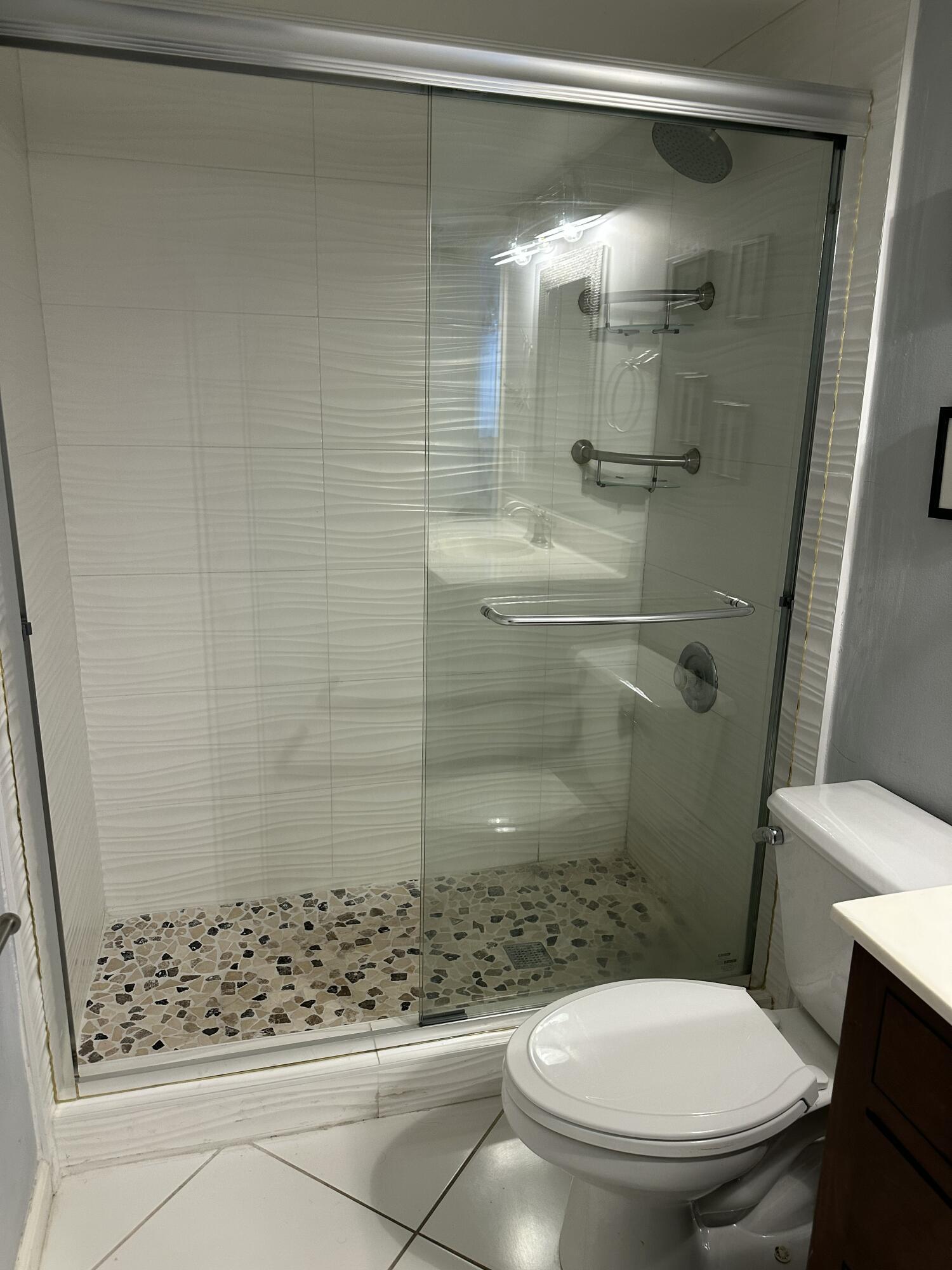 115 Spoonbill Court Jupiter, FL 33458 - Photo 35 of 52 a bathroom with a shower and a toilet