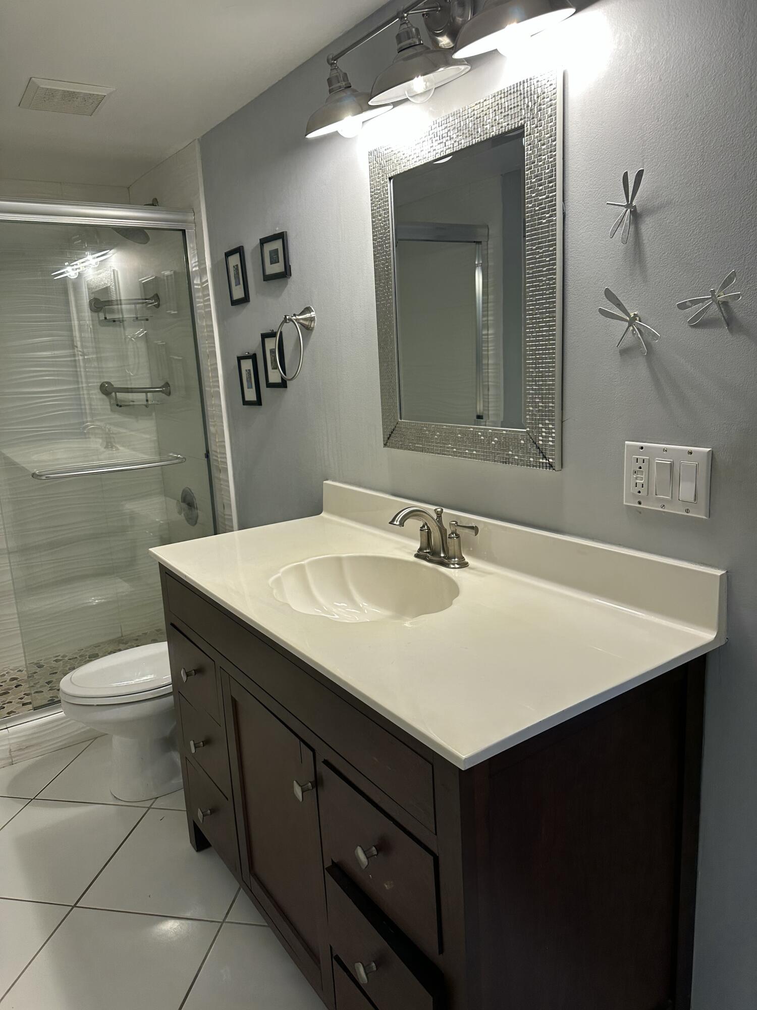 115 Spoonbill Court Jupiter, FL 33458 - Photo 36 of 52 a bathroom with a sink vanity and a toilet