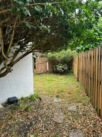 a view of a swimming pool with a yard