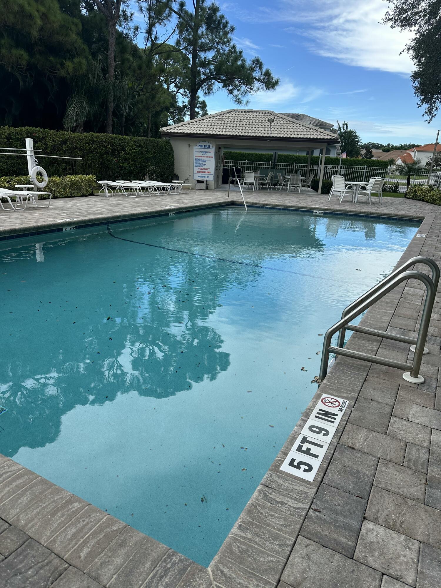 115 Spoonbill Court Jupiter, FL 33458 - Photo 50 of 52 a view of a swimming pool with a yard
