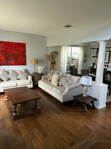 a living room with furniture and wooden floor