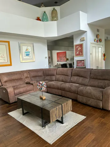 a living room with furniture and a wooden floor