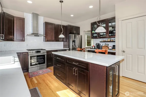 a kitchen with stainless steel appliances granite countertop a sink stove and refrigerator