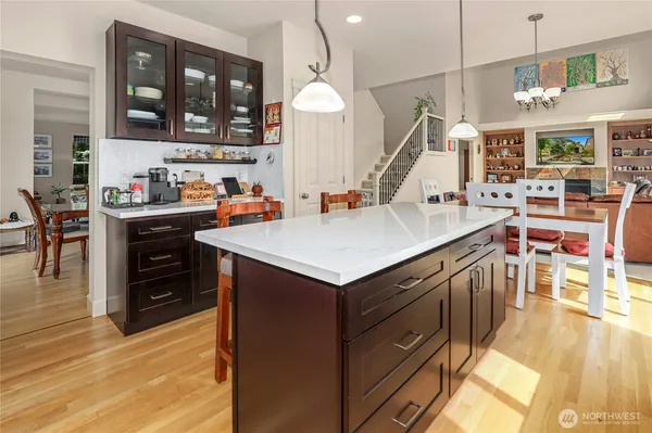 a kitchen that has a lot of cabinets and wooden floor