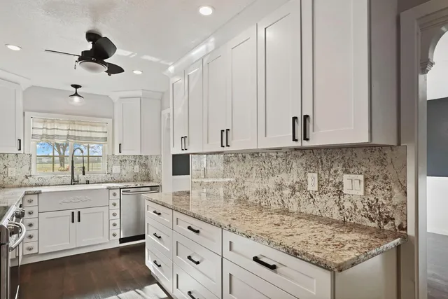a kitchen with sink cabinets and chandelier