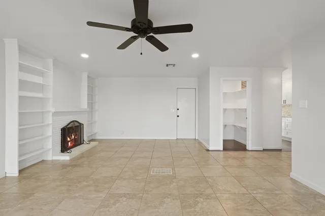 a view of an empty room and fire place