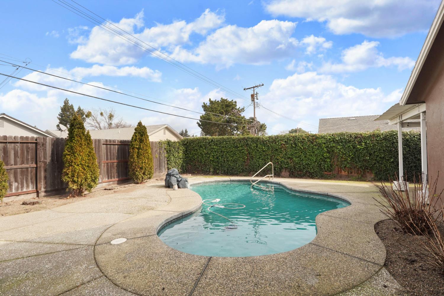 1525 West Vine Street Lodi, CA 95242 - Photo 33 of 36 a swimming pool with outdoor seating and yard in back