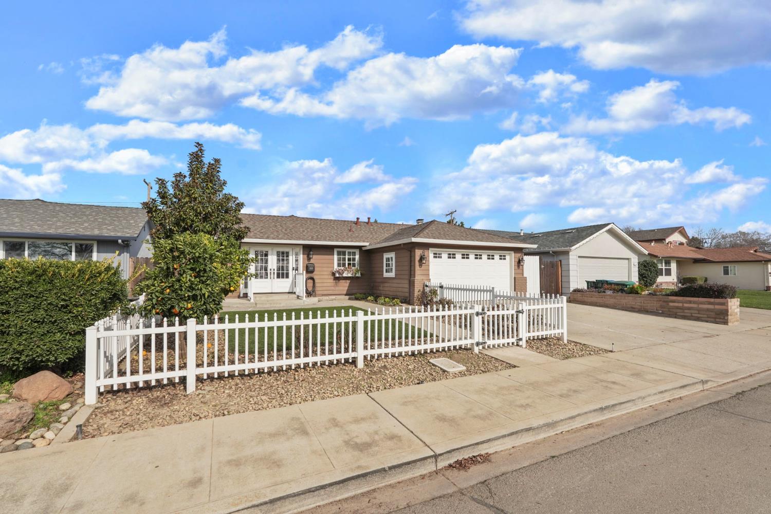 1525 West Vine Street Lodi, CA 95242 - Photo 5 of 36 a view of a house with a fence