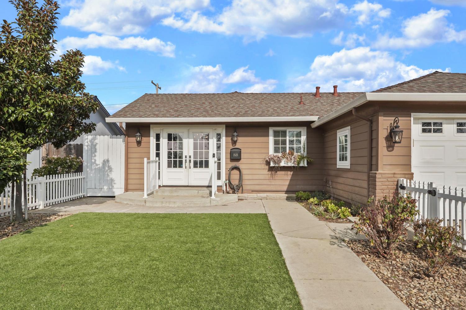 1525 West Vine Street Lodi, CA 95242 - Photo 6 of 36 a front view of a house with a yard and porch
