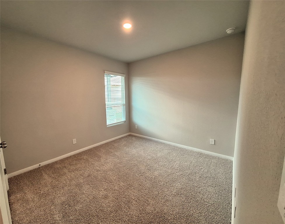 104 Gunner Road, Unit B Buda, TX 78610 - Photo 13 of 22 an empty room with windows and closet