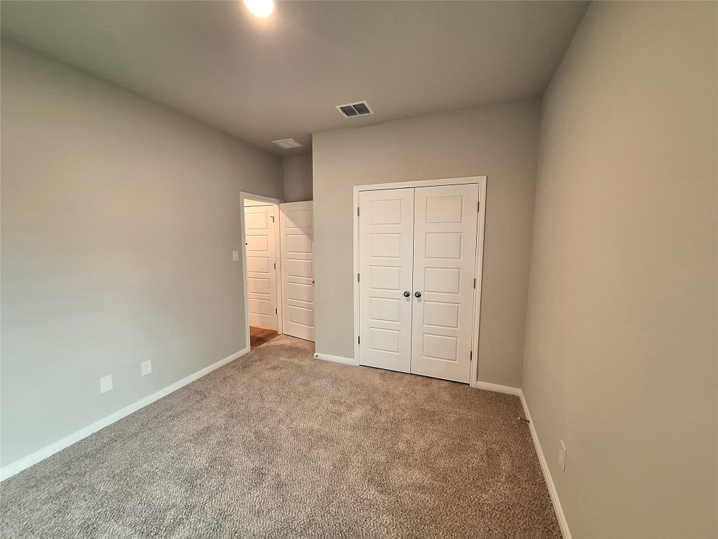104 Gunner Road, Unit B Buda, TX 78610 - Photo 14 of 22 a view of an empty room and window