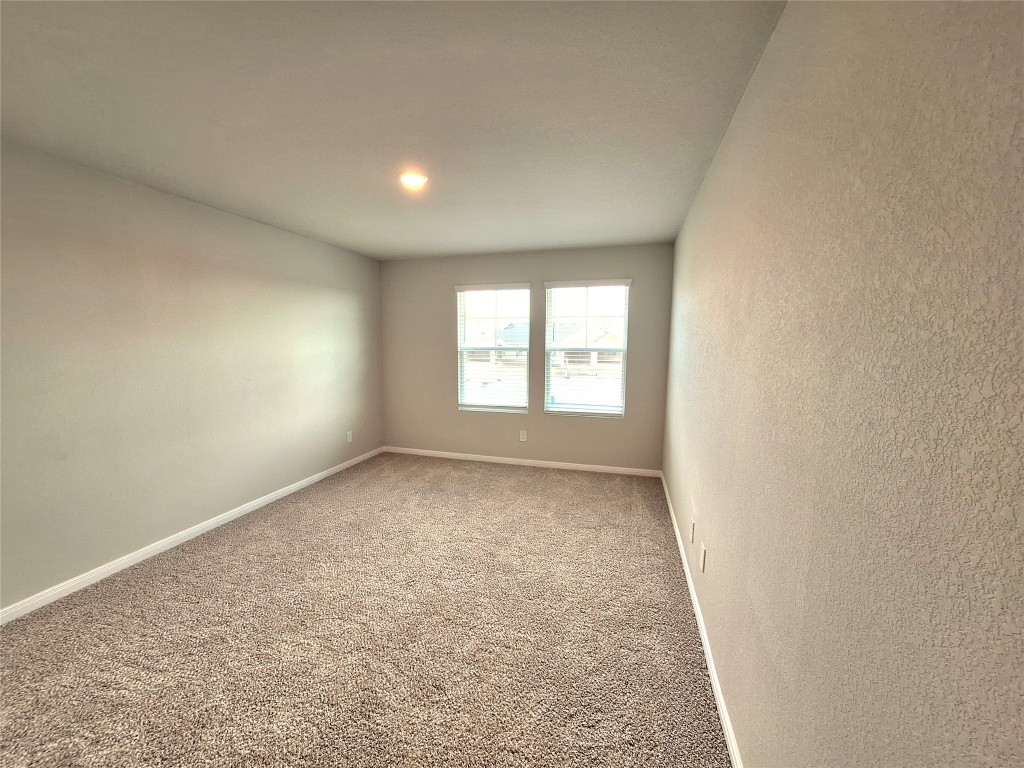 104 Gunner Road, Unit B Buda, TX 78610 - Photo 19 of 22 an empty room with a window