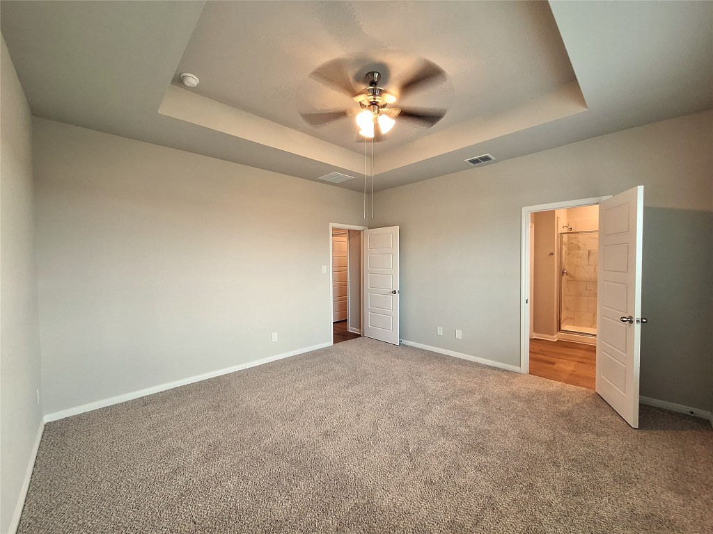 104 Gunner Road, Unit B Buda, TX 78610 - Photo 8 of 22 a view of an empty room with a chandelier fan