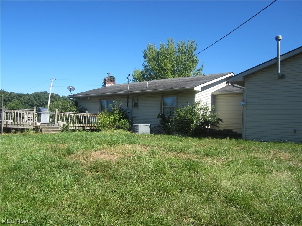 2191 Hoover Road Waterford, OH 45786 - Photo 8 of 30 Back of property with central air condition unit and wooden deck
