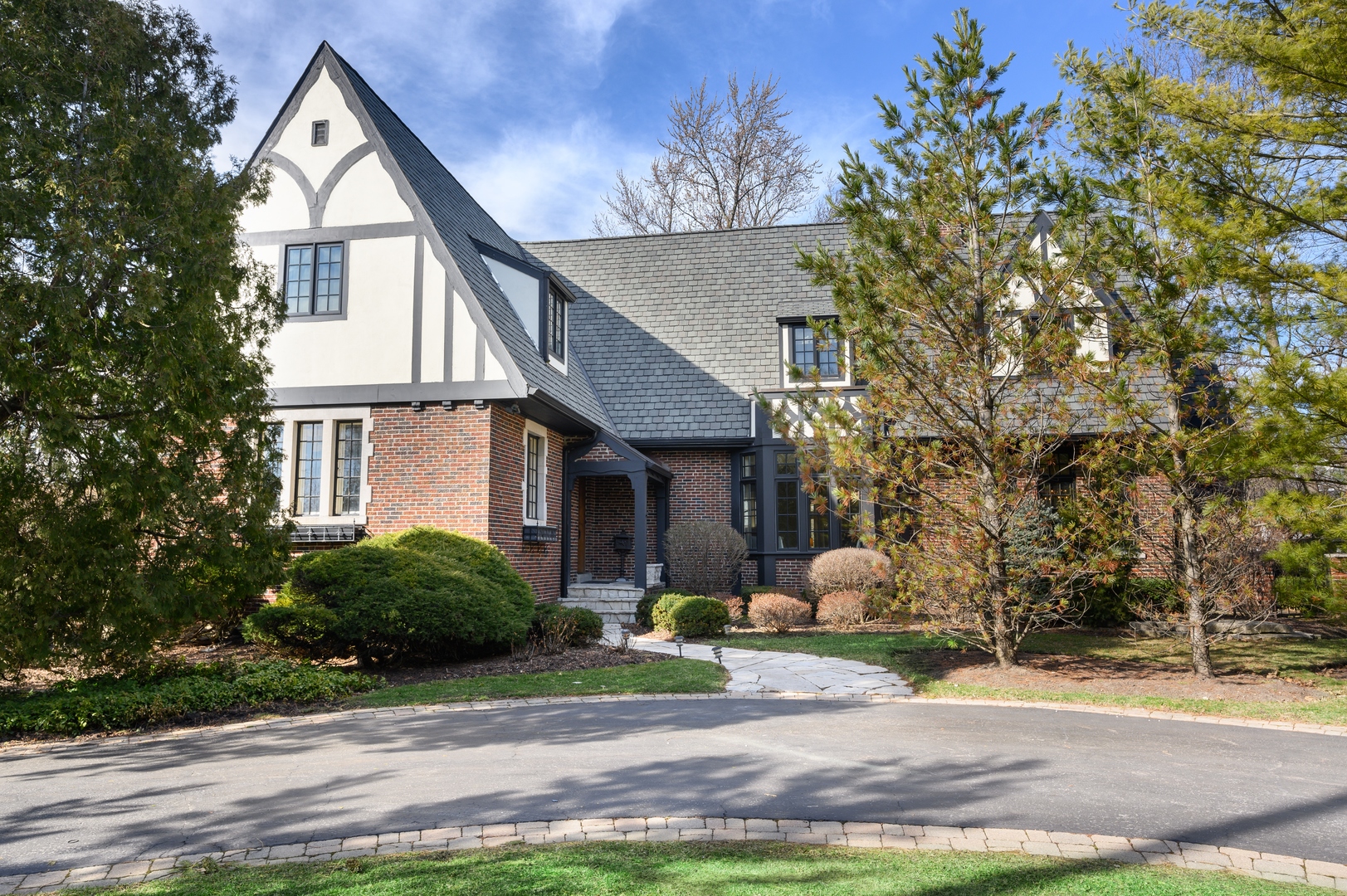 1435 Tower Road Winnetka, IL 60093 - Photo 1 of 34 a front view of a house with garden and trees