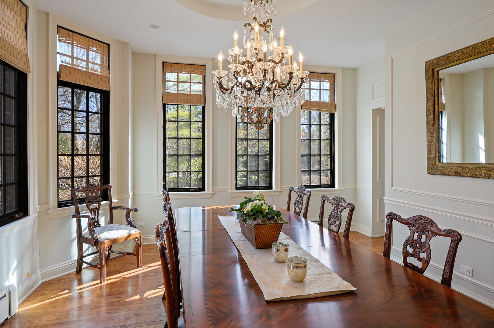 1435 Tower Road Winnetka, IL 60093 - Photo 11 of 34 a dining room with wooden floor a chandelier a glass table and chairs
