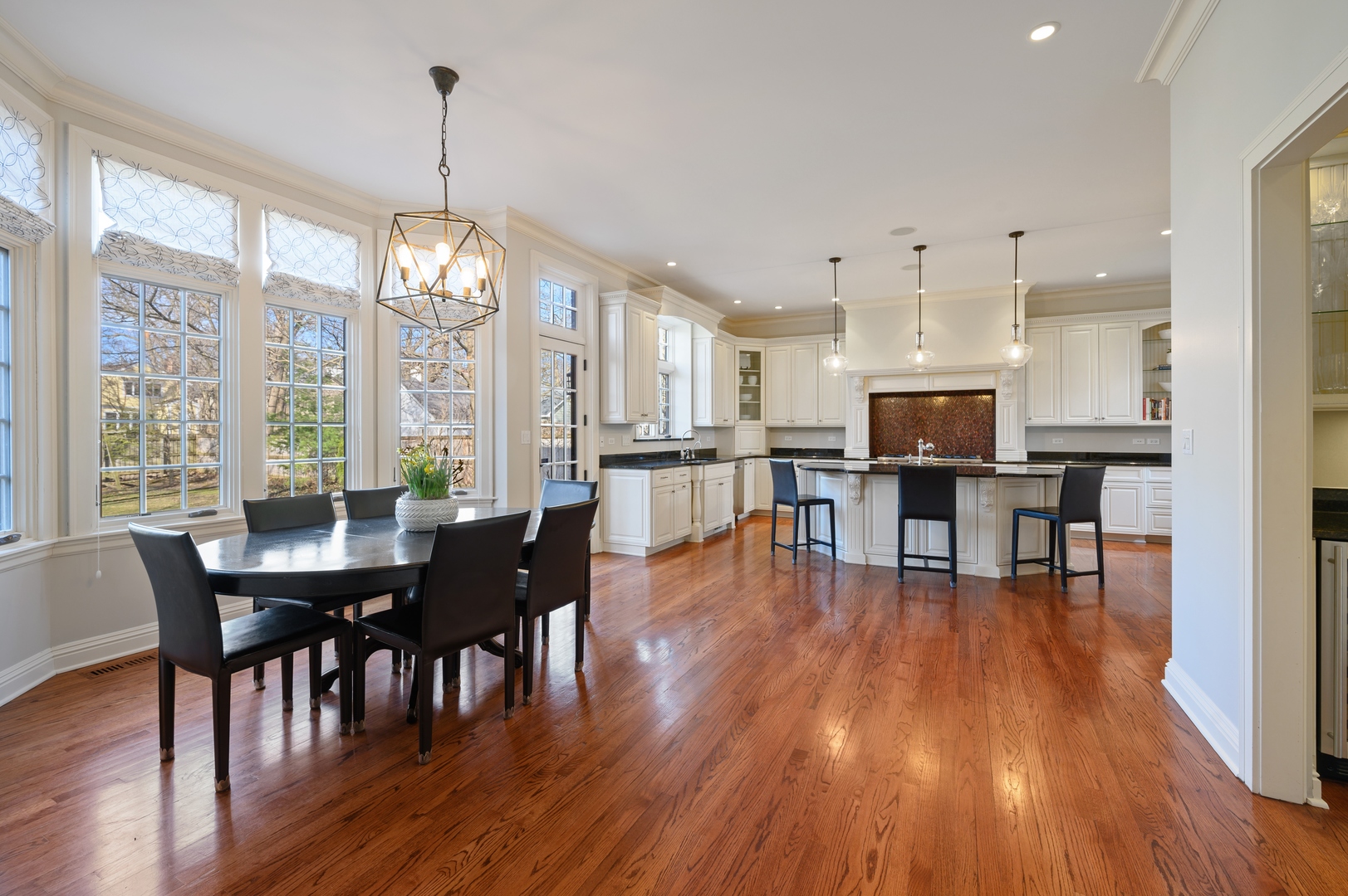 1435 Tower Road Winnetka, IL 60093 - Photo 13 of 34 a view of a dining room and livingroom with furniture wooden floor a chandelier