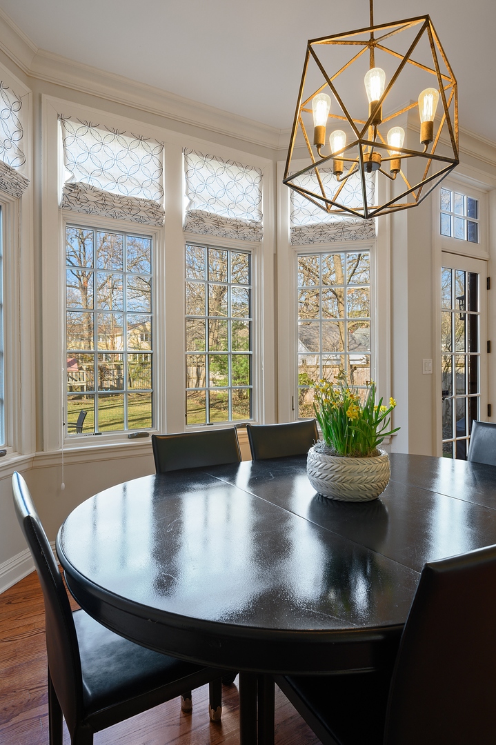 1435 Tower Road Winnetka, IL 60093 - Photo 14 of 34 a view of a dining room with furniture a potted plant and wooden floor