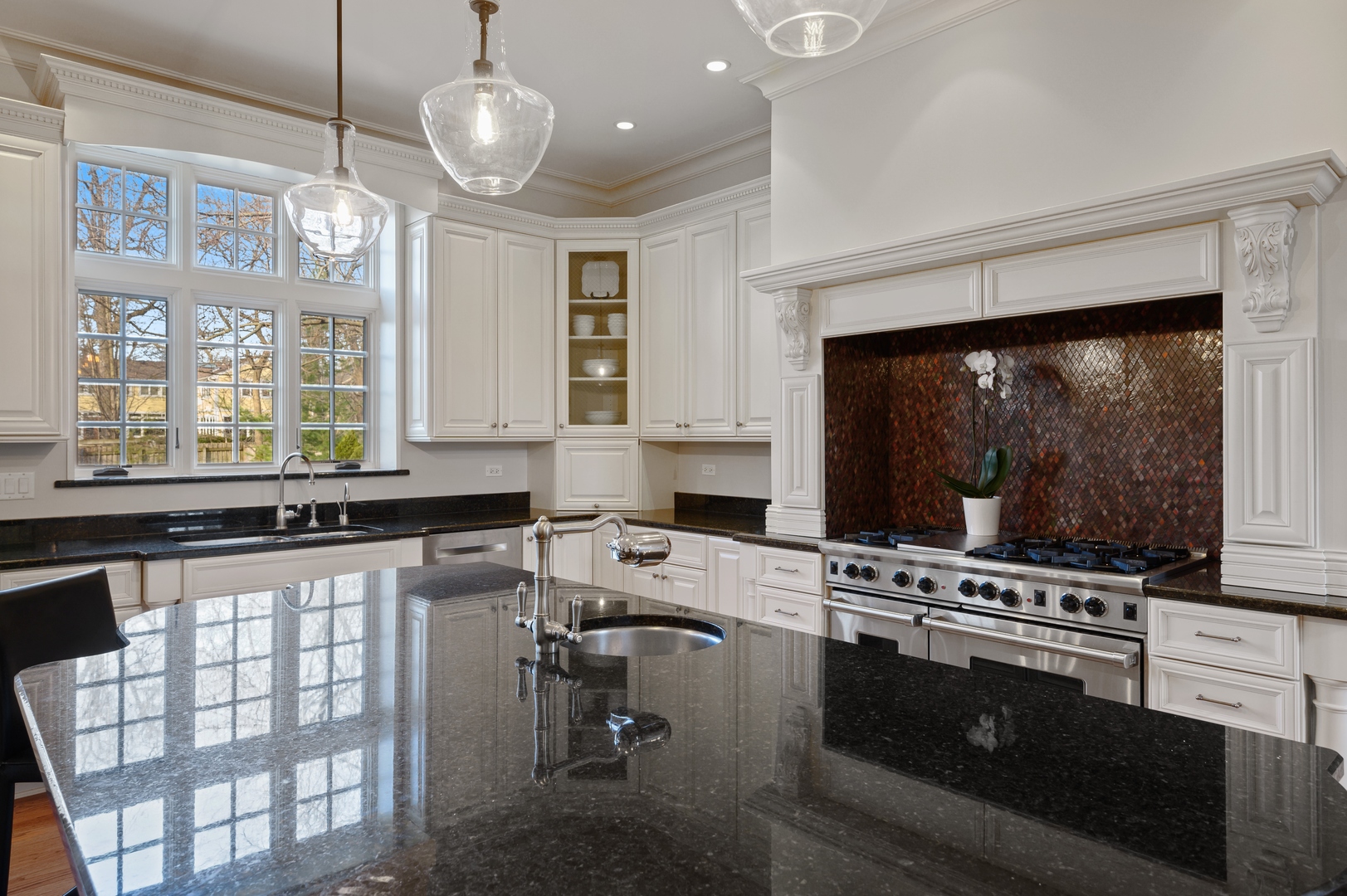 1435 Tower Road Winnetka, IL 60093 - Photo 15 of 34 a kitchen with stainless steel appliances a stove a sink and a refrigerator