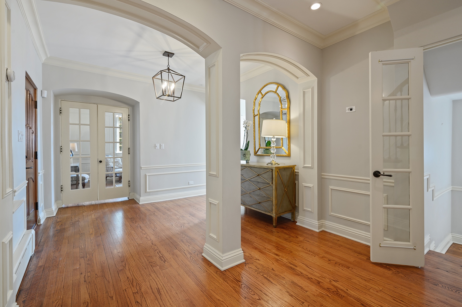 1435 Tower Road Winnetka, IL 60093 - Photo 3 of 34 a view of a hallway with wooden floor and a bathroom